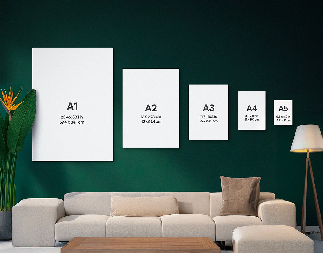 Set of framed prints with dimensions on a wall above a sofa.